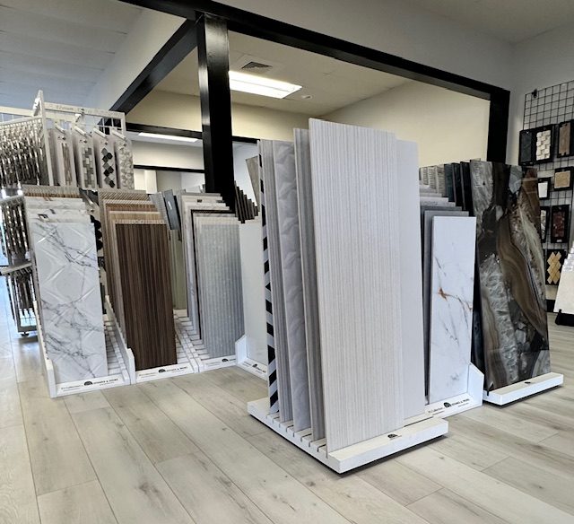 Inside the Cabinet and Flooring Outlet showroom, with cabinet, tile, and flooring selections on display